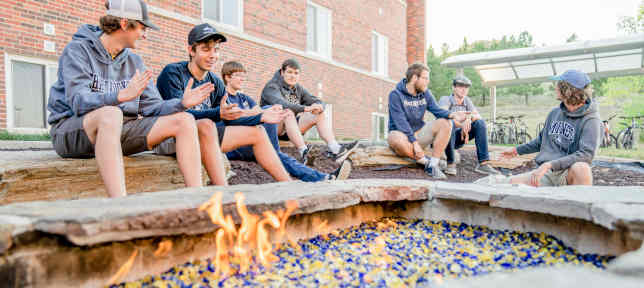Students Sitting Around Fire
