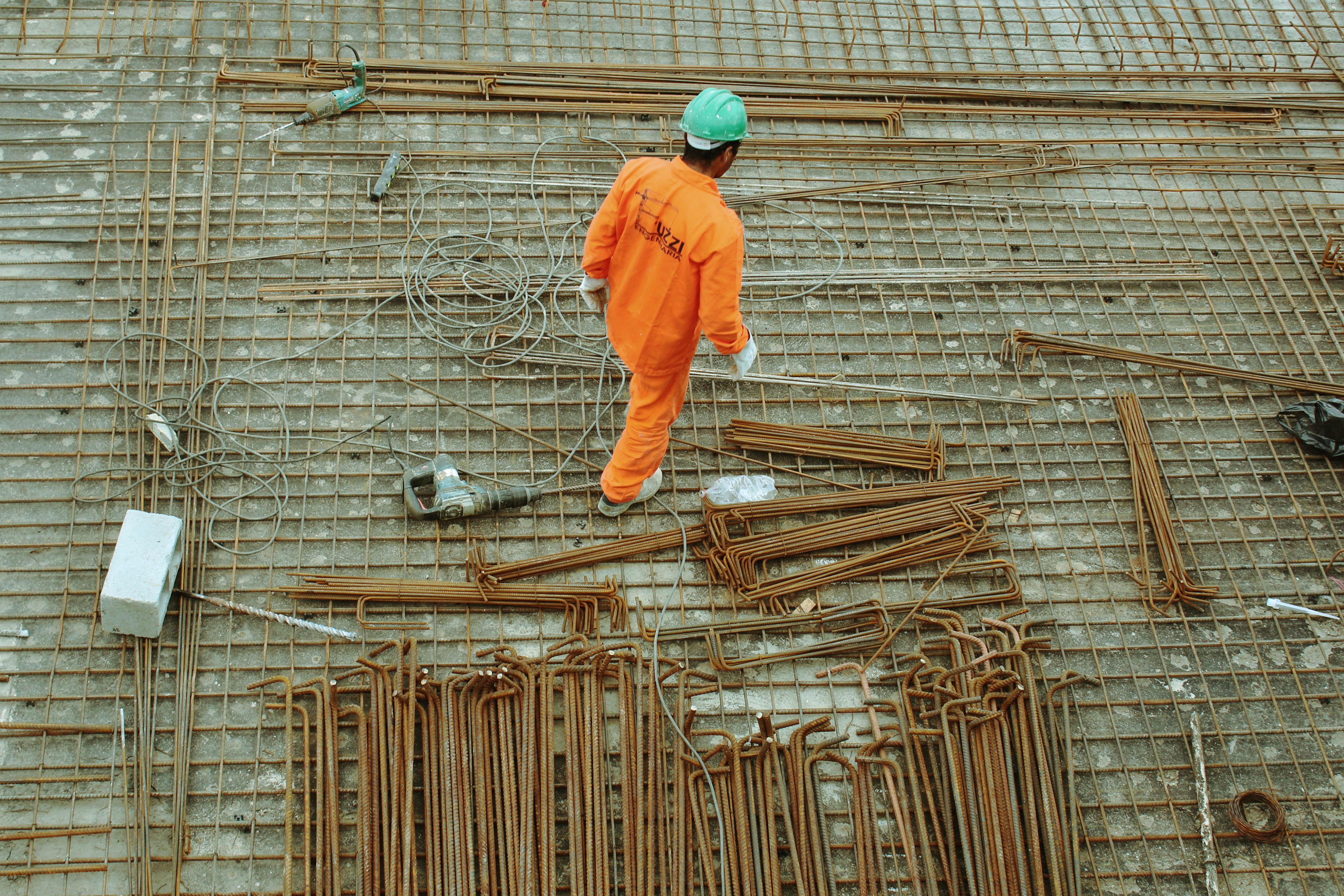 Construction worker working with steel rebar at a job site.