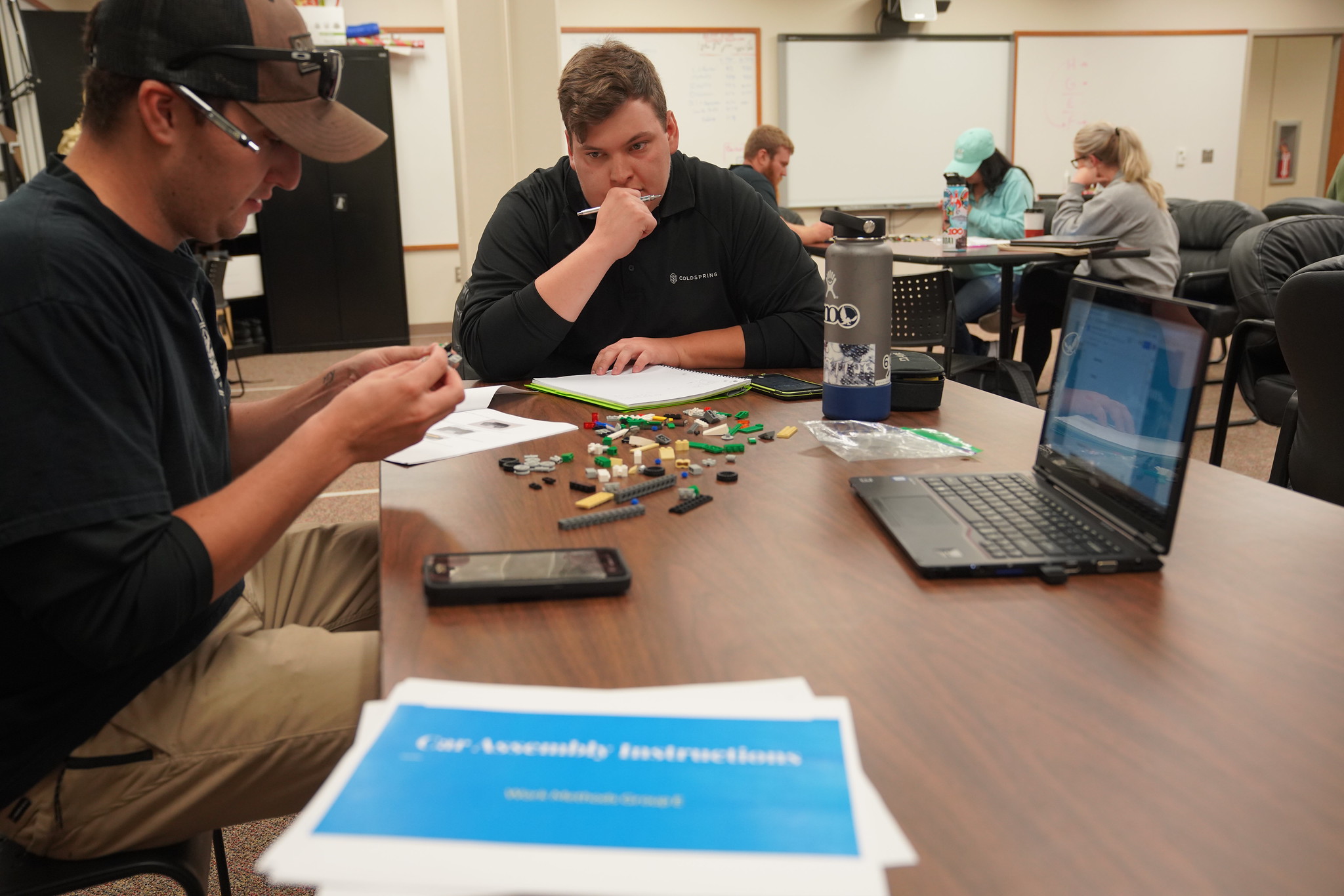 Students working on a group project together at a table.