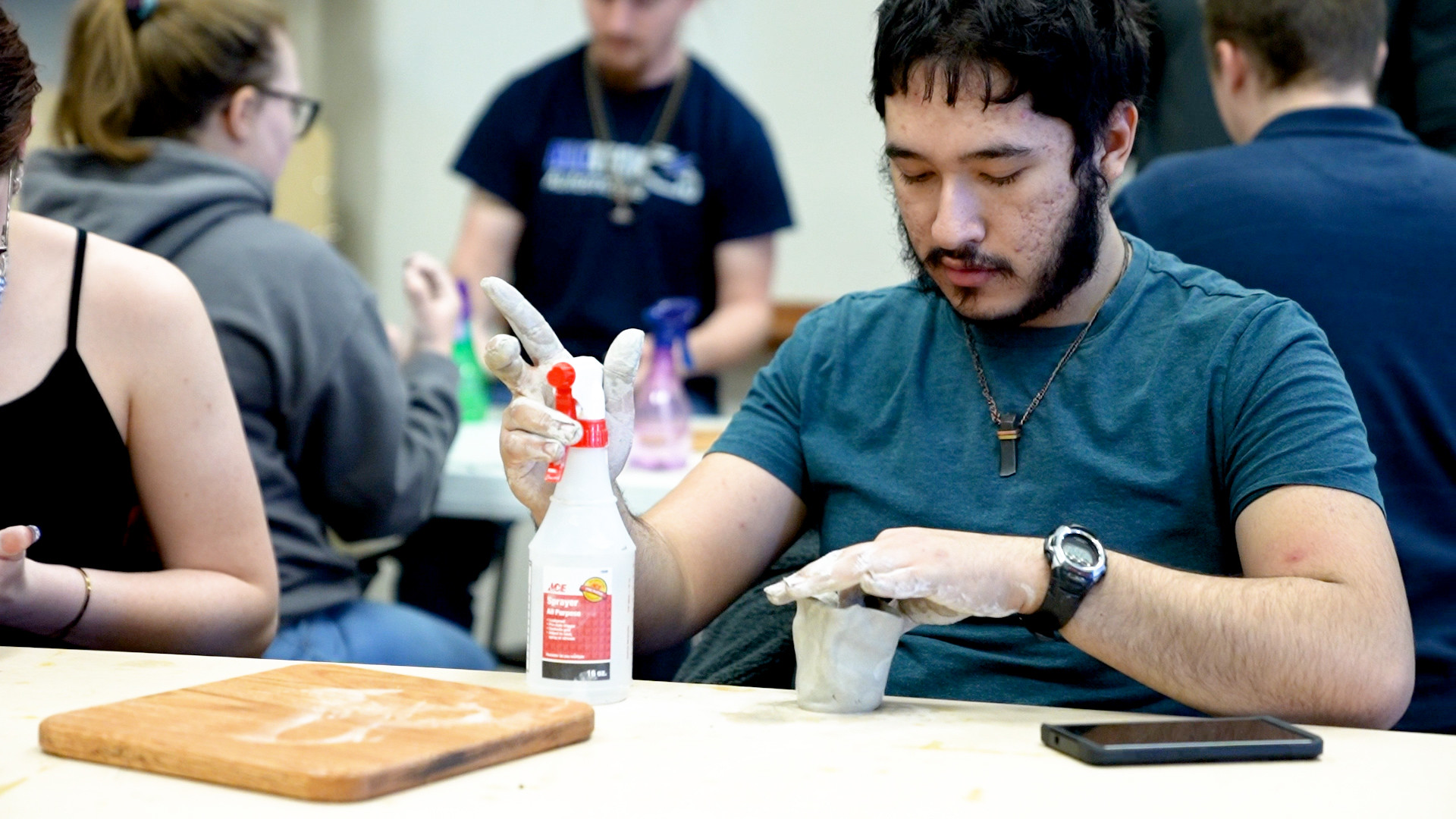 Student working with materials and tools in a classroom lab setting.
