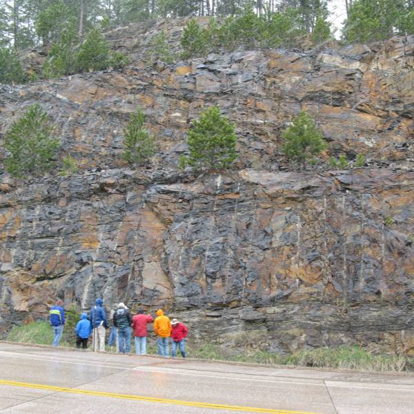 Geology Workers in front of Rock Wall