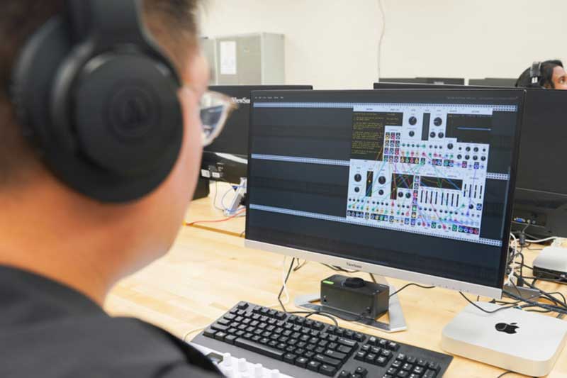 Student working on a computer with complex software.