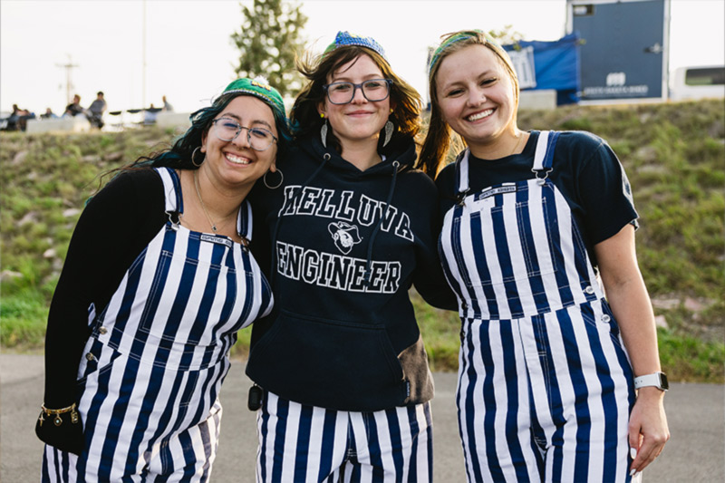 Girls in striped overalls posing at game