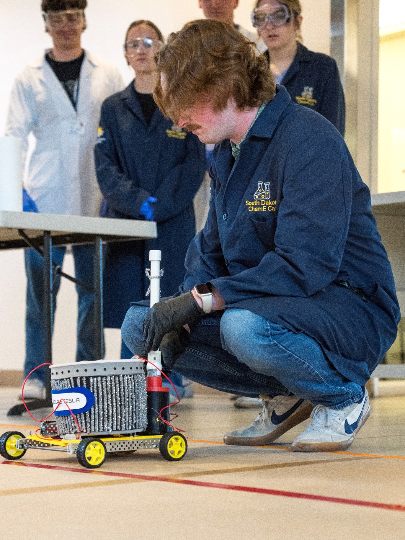 A Mines team with its Nicola’s Tesla, zinc/copper battery-powered car at the starting line.