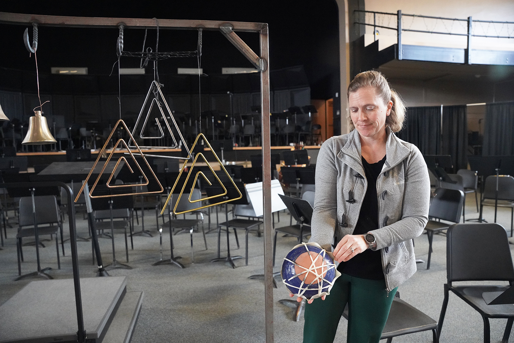 Haley Armstrong, South Dakota Mines associate professor and director of bands at Mines, displays some of the student-made instruments. 